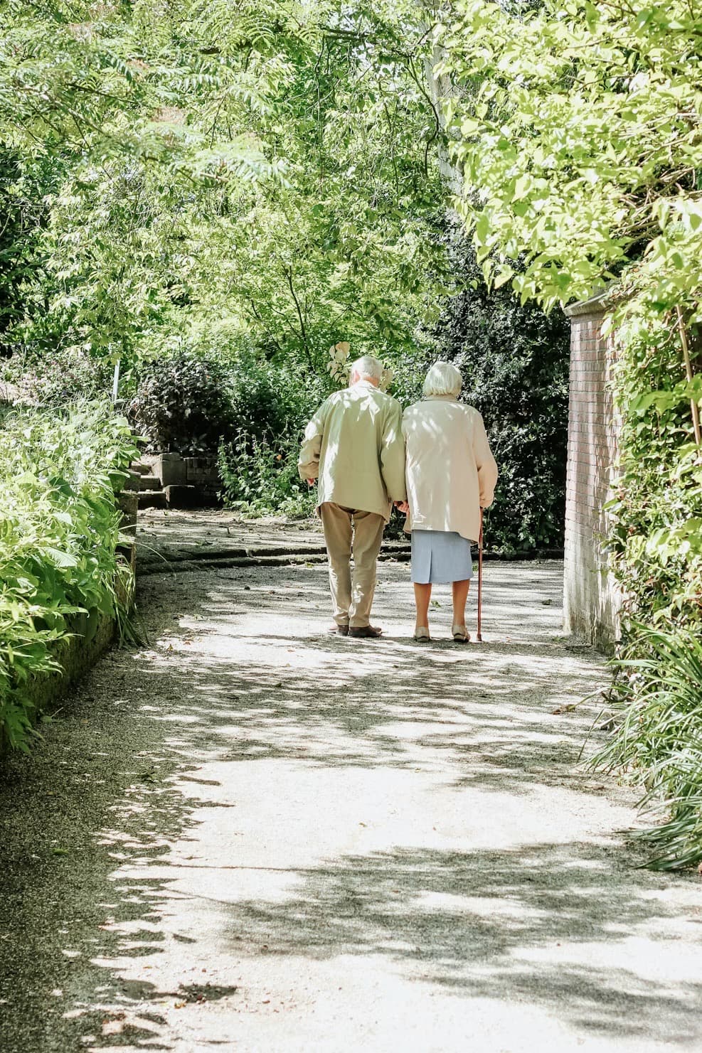 An older couple walking together, arm in arm